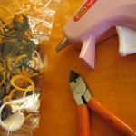 Plastic rings, wire cutters, hot glue gun