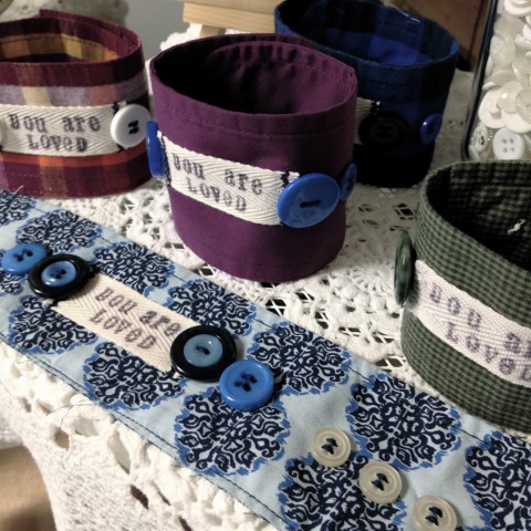 "You Are Loved" upcycled cuff bracelets with hand stamped labels.