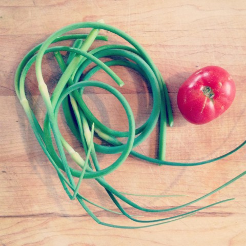 We had a surprise harvest of garlic scapes from our garden (pretty sure hubby must have slipped them in at some point since he's growing them for his CSA customers). We also harvested our first tomato of the season!! The vines are loaded and this hot weather is helping them ripen in record time (insert proud tomato growing mama smile).