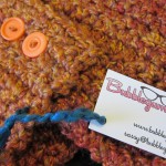 Crochet scarflette with tag