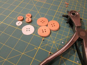 Leather buttons with their holes punched